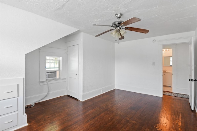 interior space with a textured ceiling, ceiling fan, and dark wood-type flooring