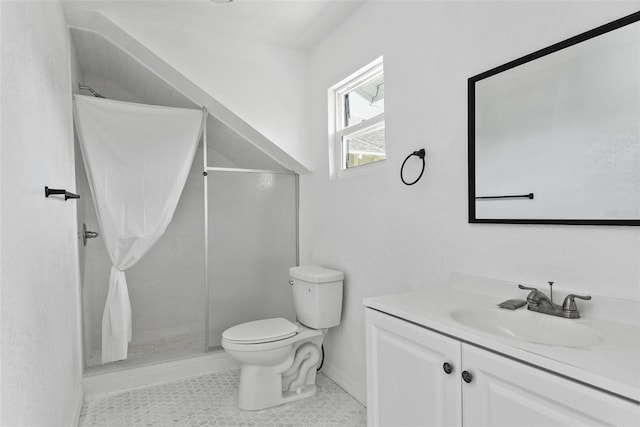 bathroom with toilet, large vanity, a tile shower, and tile flooring