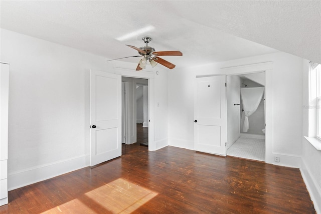 empty room featuring dark hardwood / wood-style flooring, a textured ceiling, and ceiling fan