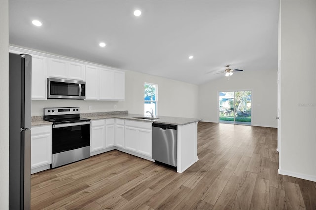 kitchen featuring light wood-type flooring, ceiling fan, appliances with stainless steel finishes, and white cabinetry