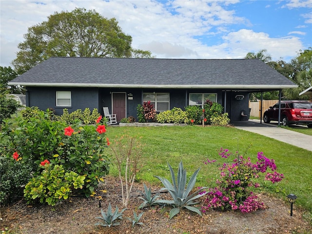 ranch-style house featuring a carport and a front yard