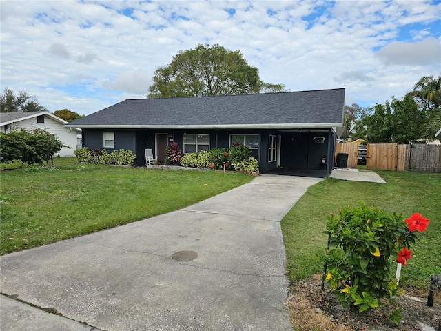 ranch-style house featuring a carport and a front lawn