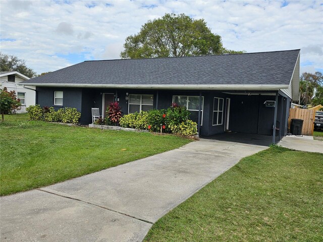 ranch-style home featuring a carport and a front yard