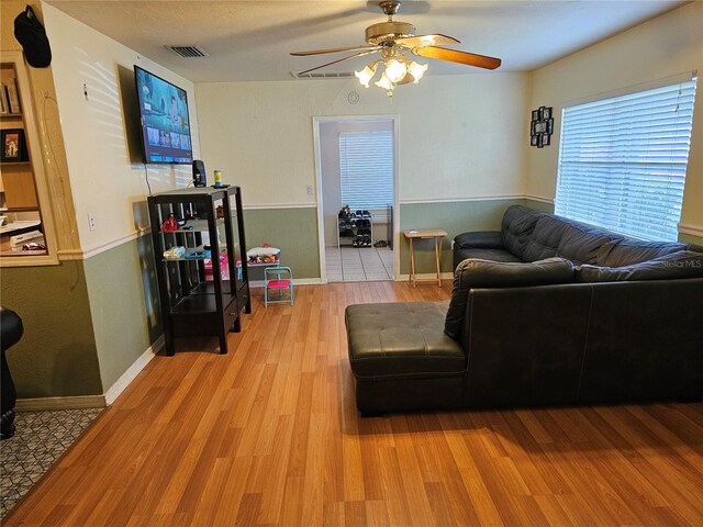 living room featuring ceiling fan and light wood-type flooring