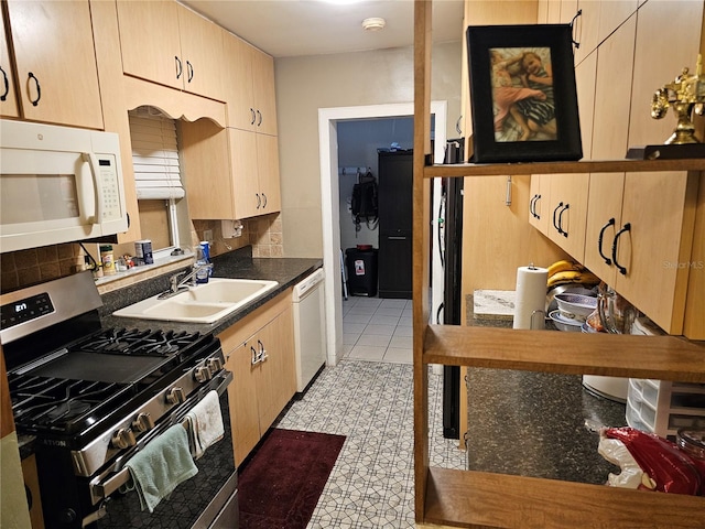 kitchen with sink, light brown cabinetry, and white appliances