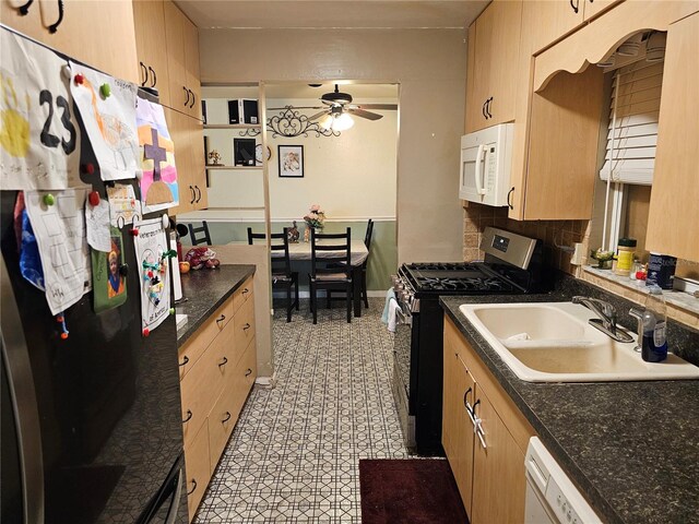 kitchen with white appliances, light brown cabinetry, sink, and decorative backsplash