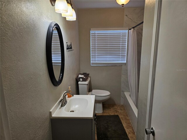 full bathroom with vanity, shower / tub combo, and toilet