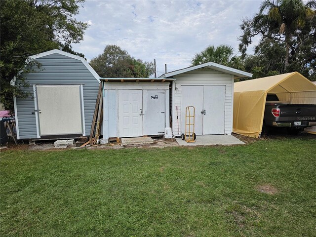 view of outbuilding with a lawn