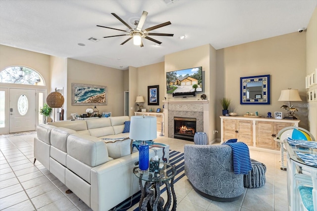 living room featuring ceiling fan and light tile floors