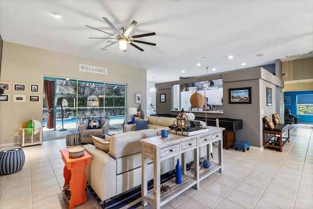 tiled living room featuring a healthy amount of sunlight and ceiling fan