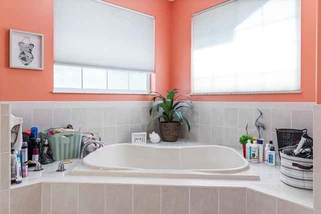 bathroom featuring tiled tub