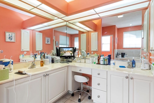 interior space with light tile floors, white cabinets, and sink