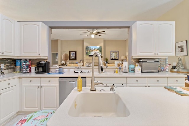 kitchen with white cabinetry, backsplash, ceiling fan, sink, and dishwasher