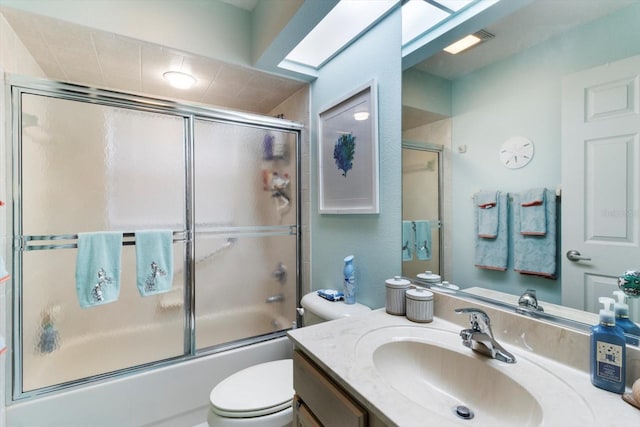 full bathroom with toilet, combined bath / shower with glass door, and vanity