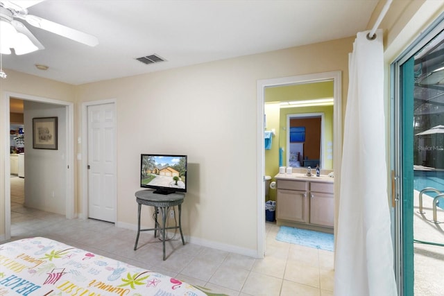 bedroom featuring light tile flooring, ensuite bath, ceiling fan, and sink