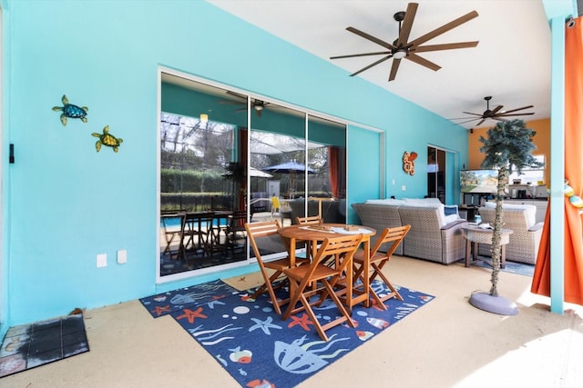 carpeted dining room with ceiling fan