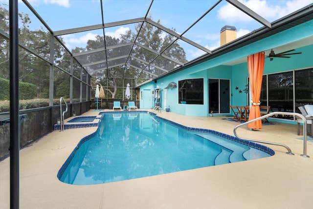 view of swimming pool featuring a patio area, ceiling fan, and a lanai