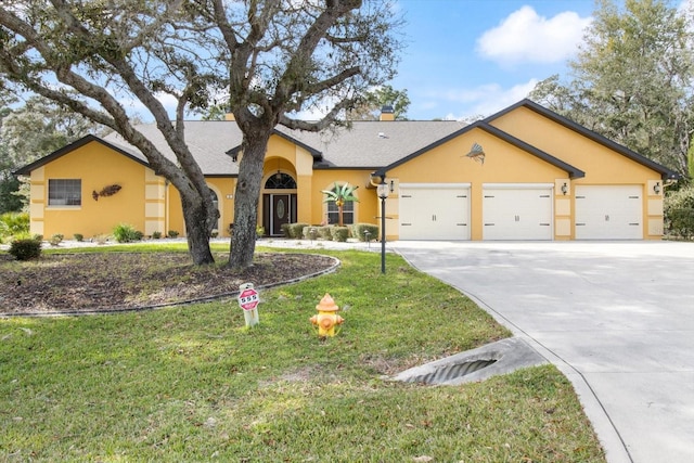 ranch-style house featuring a front yard and a garage