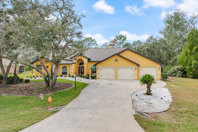 view of front of property with a front yard and a garage