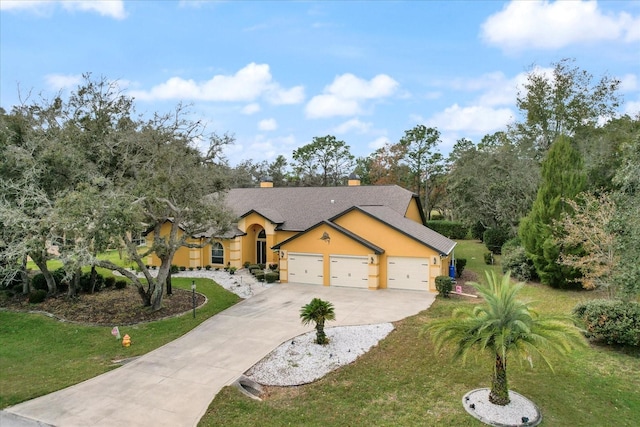 view of front of property with a front yard and a garage