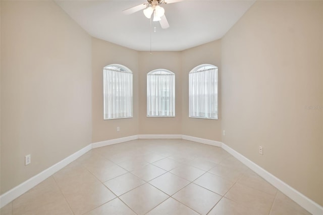 tiled spare room with ceiling fan