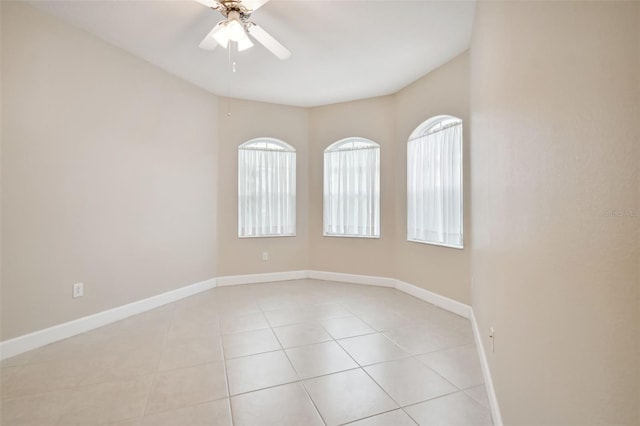 spare room with ceiling fan and light tile patterned flooring