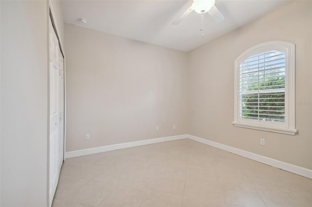 unfurnished bedroom featuring ceiling fan and light tile patterned floors