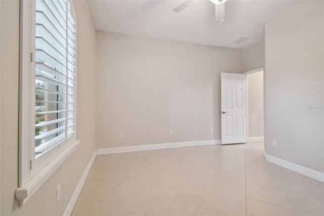 tiled empty room with ceiling fan