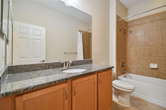 full bathroom featuring tile patterned flooring, vanity, tiled shower / bath combo, and toilet