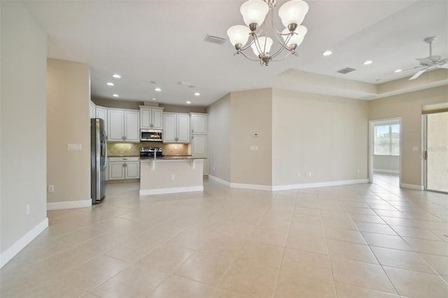 unfurnished living room featuring ceiling fan with notable chandelier and light tile patterned floors