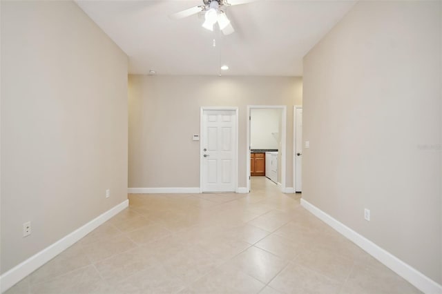 tiled empty room with washer / dryer and ceiling fan