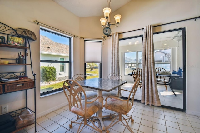 tiled dining room featuring lofted ceiling and ceiling fan with notable chandelier