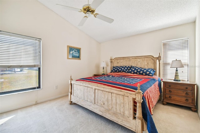 carpeted bedroom featuring lofted ceiling, a textured ceiling, and ceiling fan