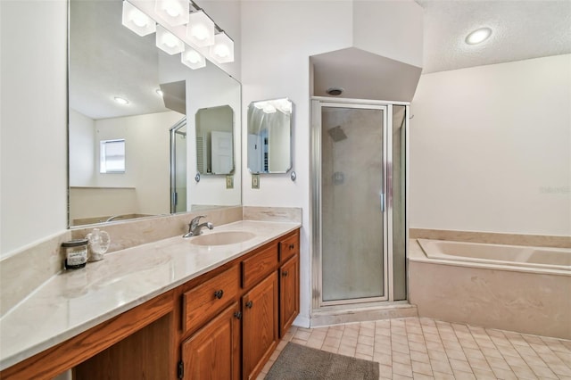 bathroom with vanity with extensive cabinet space, separate shower and tub, tile floors, and a textured ceiling