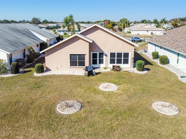 rear view of property with a yard