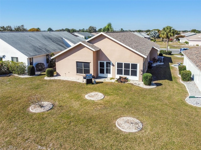 rear view of property with a lawn