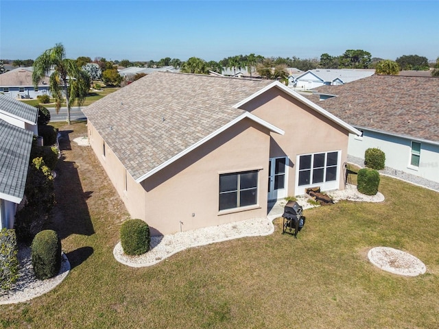 rear view of property with a yard