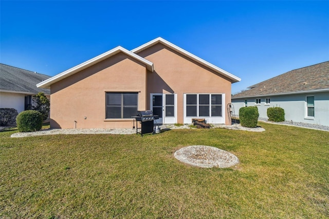 rear view of house featuring a lawn