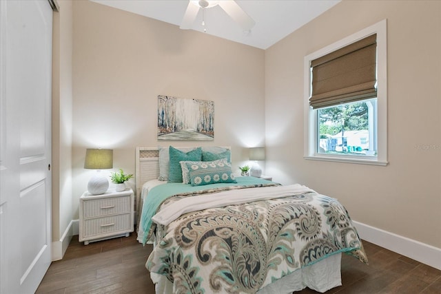 bedroom with dark hardwood / wood-style flooring and ceiling fan