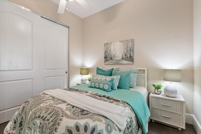 bedroom with a closet, ceiling fan, and dark hardwood / wood-style floors