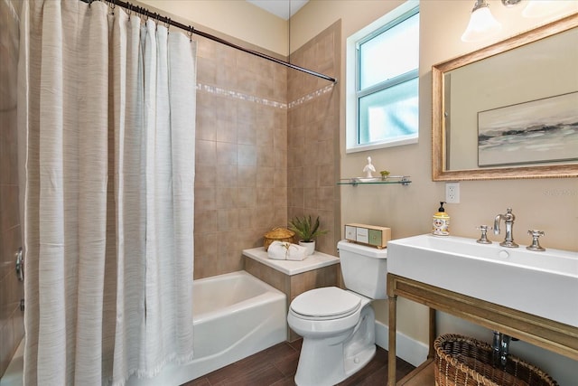 bathroom with toilet, tile floors, and shower / bath combo with shower curtain