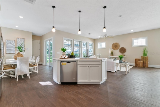 kitchen with pendant lighting, white cabinets, dark hardwood / wood-style floors, and stainless steel dishwasher