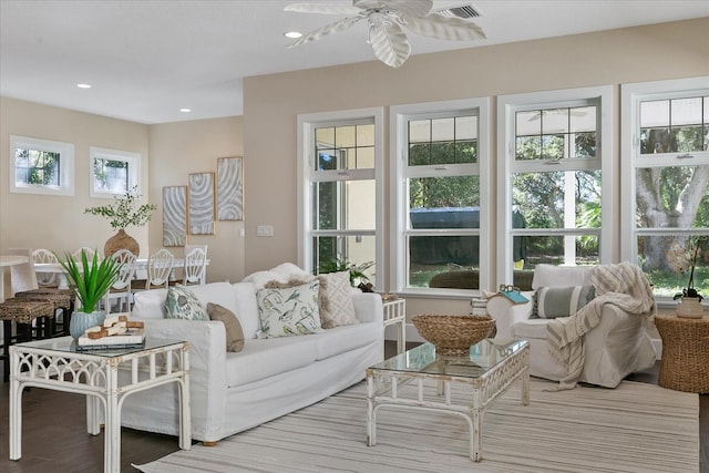 living room featuring a healthy amount of sunlight, ceiling fan, and hardwood / wood-style flooring