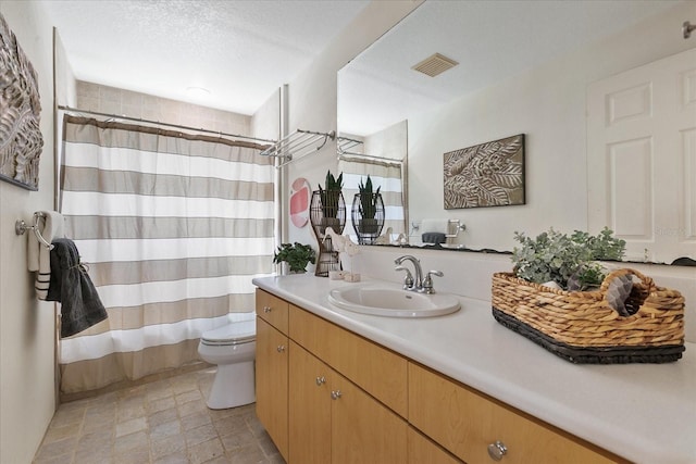 bathroom featuring oversized vanity, tile floors, and toilet