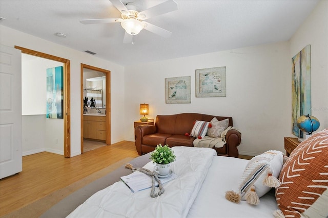 living room featuring sink, ceiling fan, and light wood-type flooring