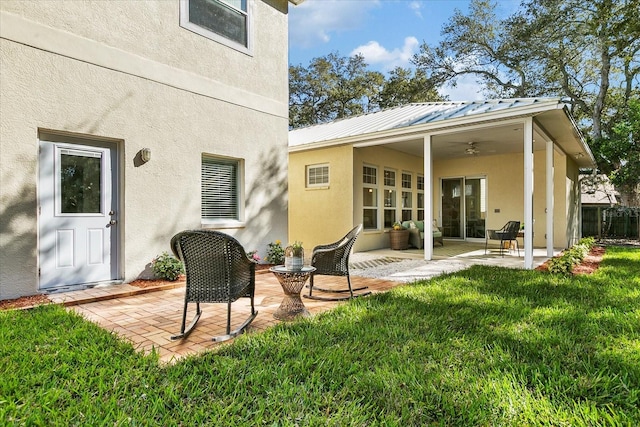 rear view of house with a patio, a lawn, and ceiling fan