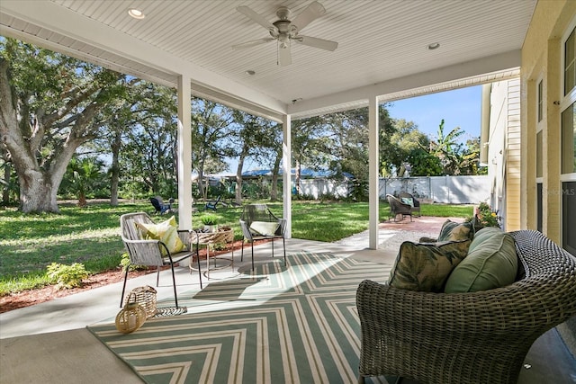 unfurnished sunroom featuring ceiling fan