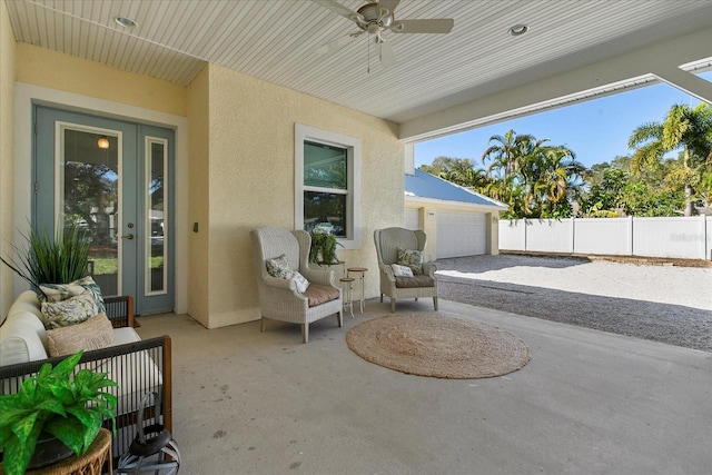 view of patio / terrace featuring ceiling fan and a garage