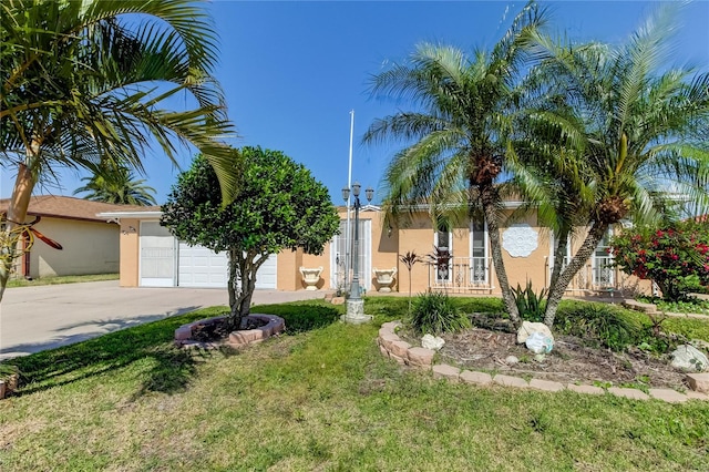 view of front of home with a garage and a front lawn