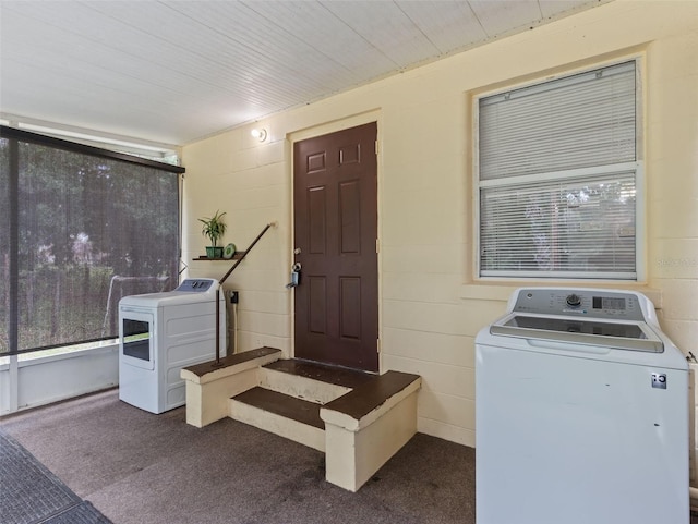 washroom featuring washer / dryer and dark carpet